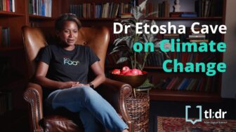 Etosha sits on an armchair in the library at X